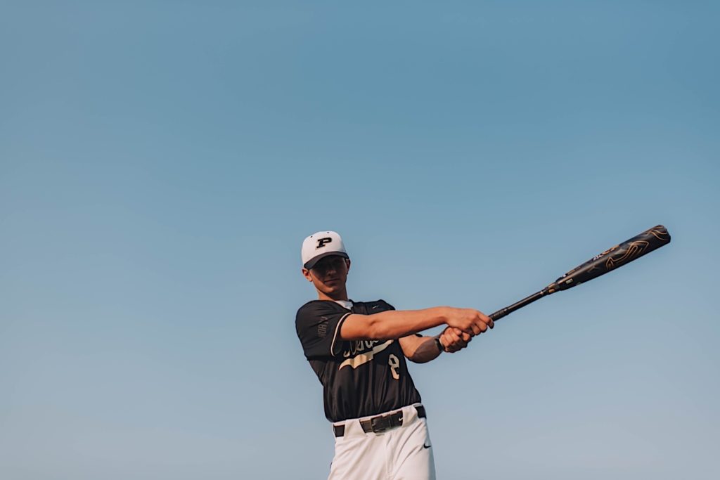Senior portrait of baseball player swinging bat