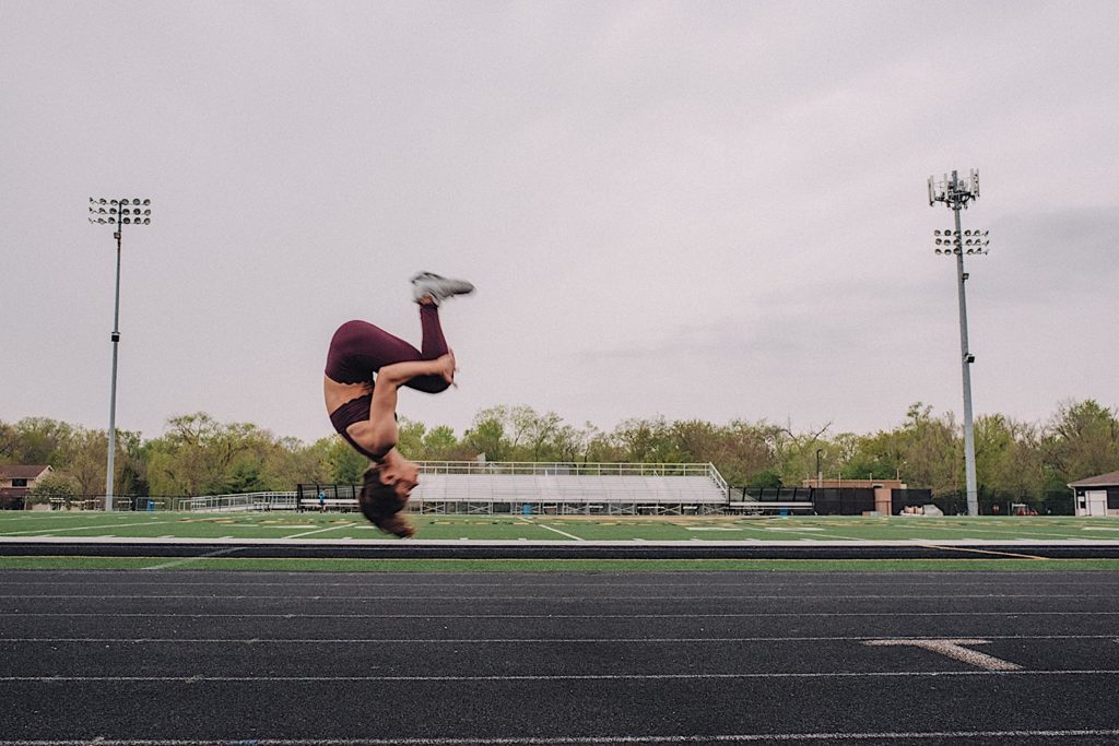 Senior does back flip for photoshoot at Wheaton Warrenville South Track