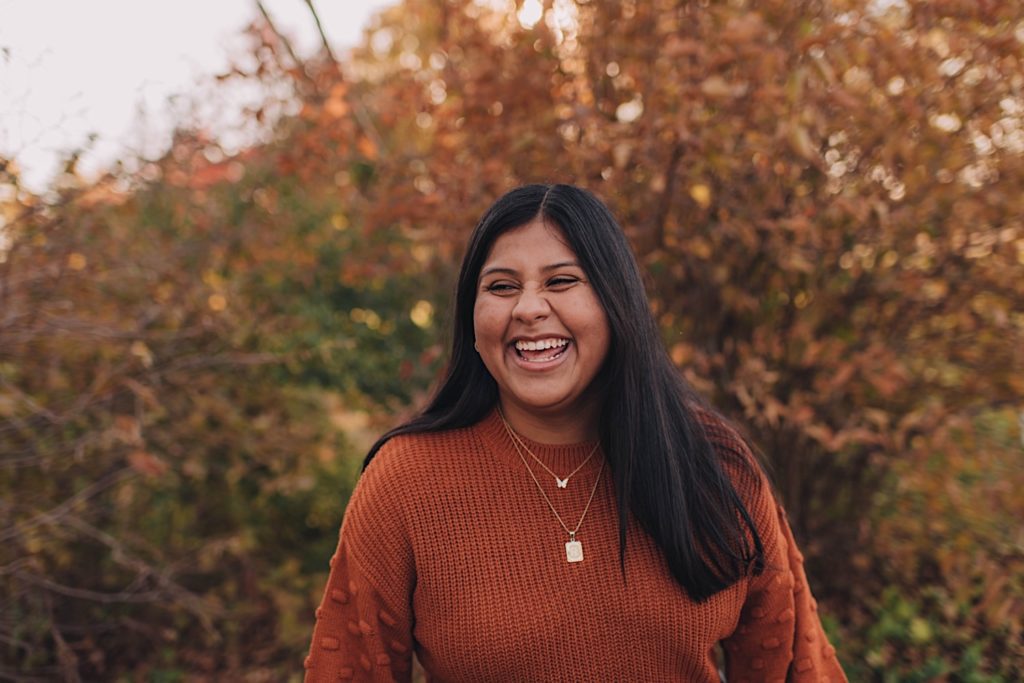Senior wearing orange sweater for photo session
